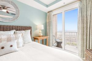 a bedroom with a bed and a large window at Beach House 432 in Tybee Island +33 photos