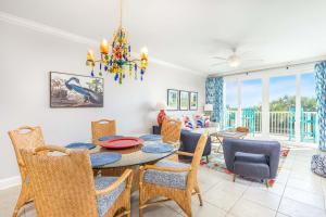 a dining room and living room with a table and chairs at Beach House 415 in Tybee Island