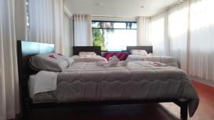 una camera da letto con due letti e una grande finestra di Illariywasi Homestay Comunidad Pueblo Isla Amantani a Ocosuyo