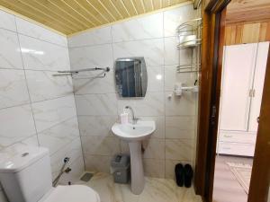a white bathroom with a sink and a toilet at Çay Pansiyon in Uzungöl +62 photos