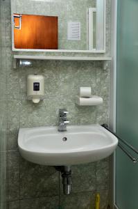 a bathroom with a white sink and a mirror at San Rocco Lumbarda in Lumbarda