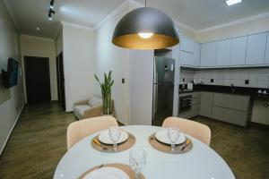 a kitchen and dining room with a table and chairs at Residência TCA in Brasilia +9 photos