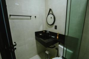 a bathroom with a black sink and a mirror at Residência TCA in Brasilia