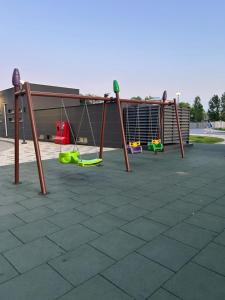a group of swings in a parking lot at ML Apartments in Odesa