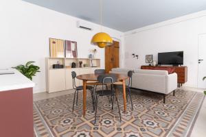 a living room with a table and a couch at Casa Umbertina in La Spezia