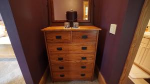 a dresser with a mirror on top of it at Cameron House Next Door in Manteo +3 photos