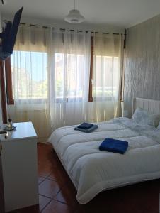 Un dormitorio con dos camas con toallas azules. en Karol Beach House, en Santa Marinella