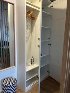 a walk in closet with a sink and a mirror at Apartament 49 in Toruń +10 photos