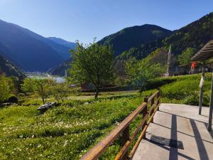 a wooden fence next to a field of flowers at Çay Pansiyon in Uzungöl
