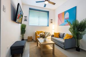a living room with a couch and a table at Spanish Lagoon San Juan with Private Patio by PH in San Juan