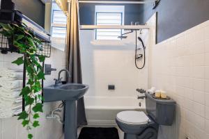a bathroom with a sink and a toilet and a tub at Spanish Lagoon San Juan with Private Patio by PH in San Juan +18 photos
