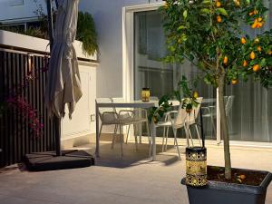 a patio with a table and chairs and a tree at Suite with Private Courtyard - Colosseum & Forum in Rome