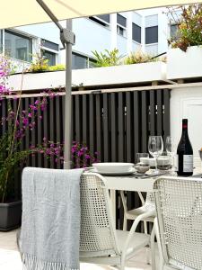 a table and chairs on a patio with a black fence at Suite with Private Courtyard - Colosseum & Forum in Rome +22 photos