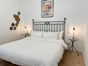 a bedroom with a white bed and two lamps at Suite with Private Courtyard - Colosseum & Forum in Rome