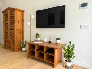 a living room with a table and a tv on a wall at Suite with Private Courtyard - Colosseum & Forum in Rome