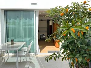 a dining room with a table and an orange tree at Suite with Private Courtyard - Colosseum & Forum in Rome