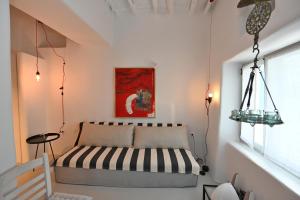 a bedroom with a bed and a window at Kariki Green Triantaros Tinos in Triandáros