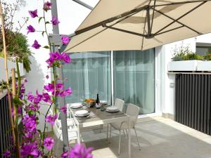 a table and chairs with an umbrella on a patio at Suite with Private Courtyard - Colosseum & Forum in Rome