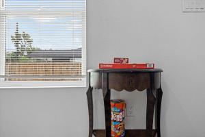 a table with a box on it next to a window at Apt Near Downtown Desk Wifi Tvs Games Pets in Houston