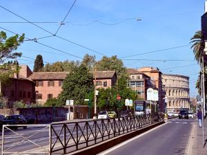 a city street with a bridge with cars and buildings at Suite with Private Courtyard - Colosseum & Forum in Rome
