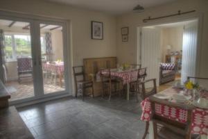 a living room with a table and a dining room at Bro Dafydd in Aberystwyth