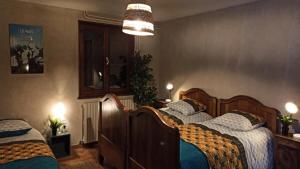 a bedroom with two beds and a chandelier at Chalet Belvedere-vallouise - Chalet avec vue sur Vallouise 9 personnes MAE-2424 in Vallouise +7 photos
