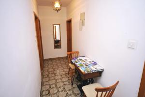 a room with a table with chairs and a table with magazines at Guesthouse Rutar in Rupa