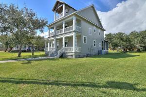 a large white house with a large grass yard at The James Pearl in Rockport