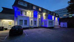 a building with blue lights on it in a parking lot at Heathlands Hotel in Bournemouth +24 photos