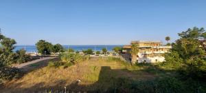 a building on a hill with the ocean in the background at Riposto Sea & Etna View Retreat in Riposto