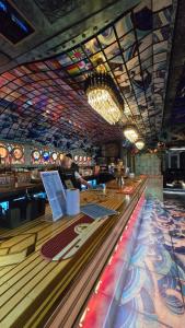 a man standing at the bar in a casino at Welsh Bayview Retreat 2-Bed Lodge at Clarach Bay Holiday Village in Aberystwyth