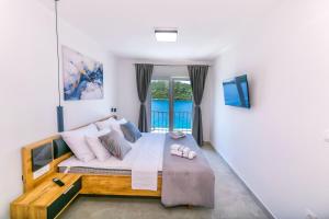 a bedroom with a large bed with a window at House Paval in Brnistrova