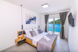 a bedroom with a large bed and a balcony at House Paval in Brnistrova