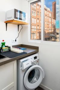 a laundry room with a washing machine and a window at Ecos del Mar - Thalassa in Peniscola