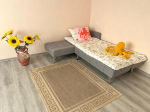 a bedroom with a bed with a yellow toy on it at Sigulda's Laimas Apartment Self-Check in in Sigulda