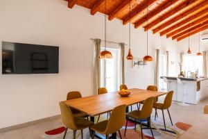 a dining room with a wooden table and chairs at Villa Veduta in Bale