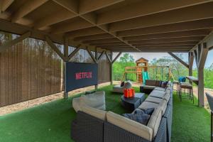a living room with a couch and a swing at Sleeps 20 Hot Tub Outdoor Theater Putt Putt Games in Fairview