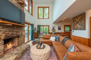 a living room with a couch and a fireplace at Sleeps 20 Hot Tub Outdoor Theater Putt Putt Games in Fairview +68 photos