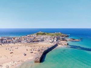 an aerial view of a beach with people and the ocean at 1 Bed in Portreath HAMIB in Redruth
