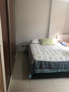 Ένα ή περισσότερα κρεβάτια σε δωμάτιο στο condominio jerico