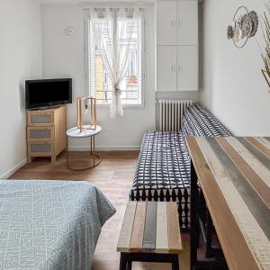 Ένα ή περισσότερα κρεβάτια σε δωμάτιο στο Studio cosy rénové, proche métro & Stade de France