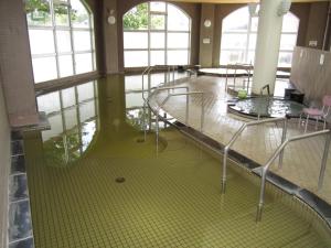 an empty room with tables and chairs and windows at Yusenkaku - Vacation STAY 94269v in Kombu