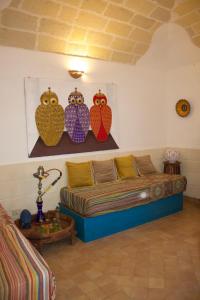 a living room with owls hanging on the wall at Casa Garibaldi , Piazza Sant'anna Favignana in Favignana