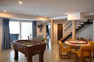 a living room with a table and a dining room at Lakeview Mid Century Luxury Cottage in Sainte-Adèle