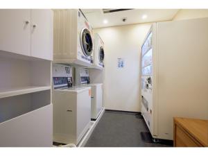 a kitchen with white cabinets and a washer and dryer at Kipp Hotel Shonan Fujisawa - Vacation STAY 05488v in Fujisawa