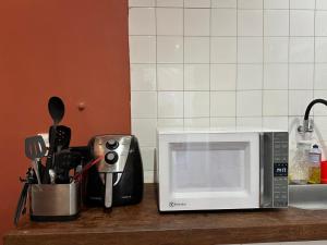 a kitchen counter with a microwave on a counter top at Maravilha in Rio de Janeiro +27 photos