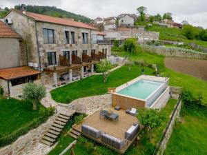 an aerial view of a house with a swimming pool at Casa Albelo do Gerês in Montalegre