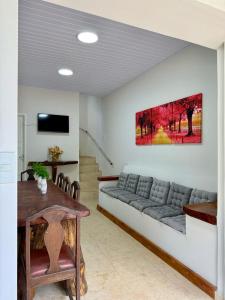 a living room with a couch and a table at Chalé das Hortênsias em São Lourenço a 2 km do Parque das Águas in São Lourenço