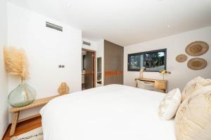 a bedroom with a white bed and a window at Villa luxe dans domaine Mougins in Mougins +12 photos