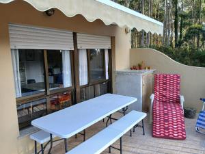 a white table and chairs on a patio at La terraza de Isabel in O Barqueiro